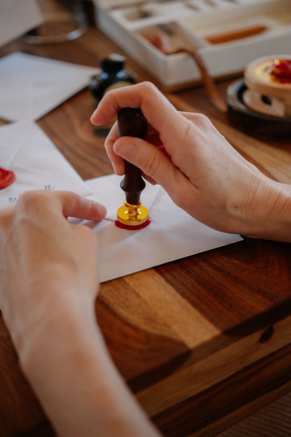 A wax-sealed letter beside a rakhi